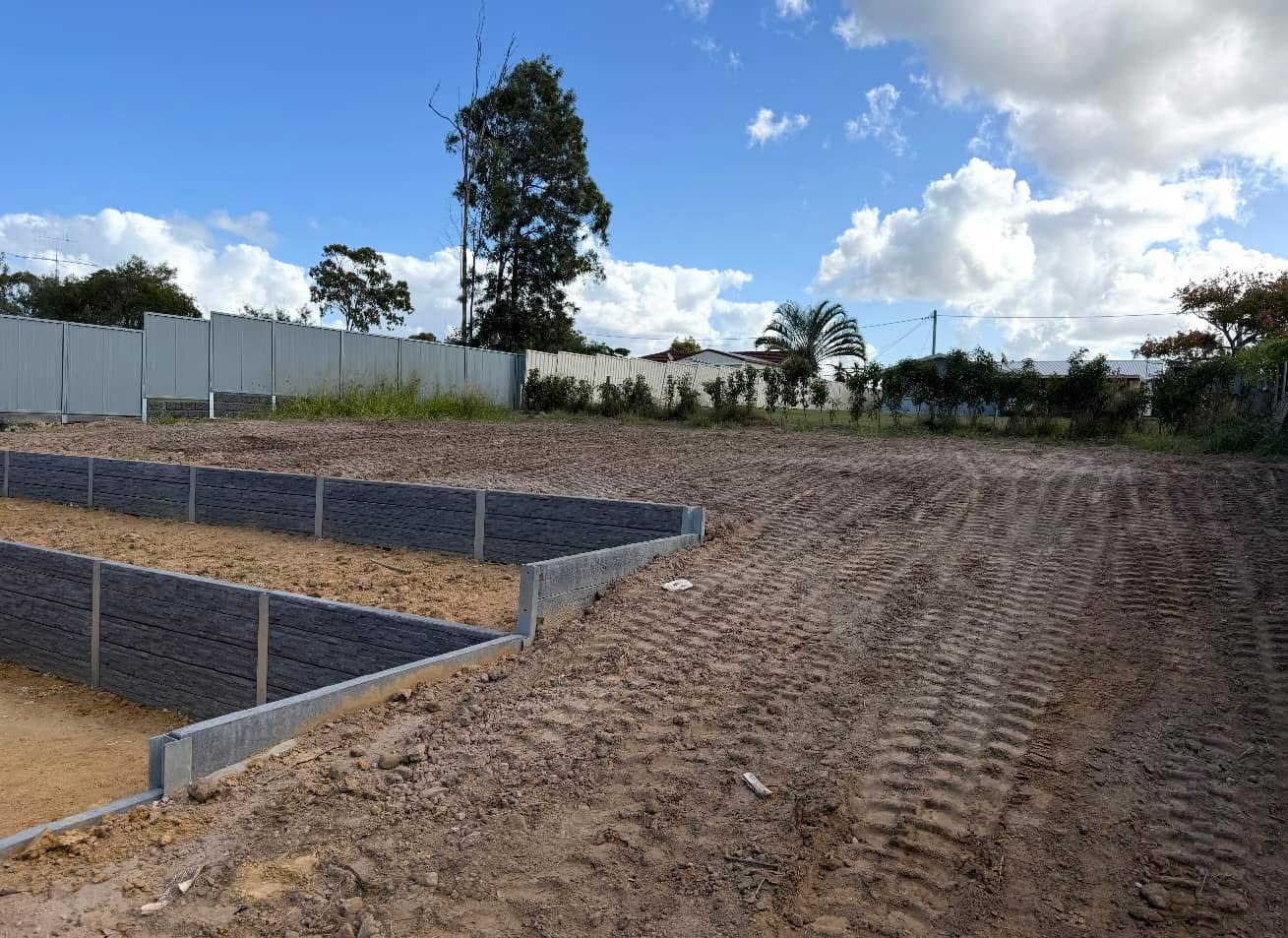 Graded earthworks beside two terraced areas